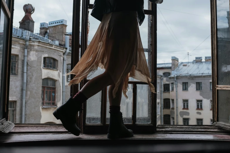 a woman that is standing in front of a window, an album cover, pexels contest winner, combat boots, alexey gurylev, wearing a skirt, walking to the right