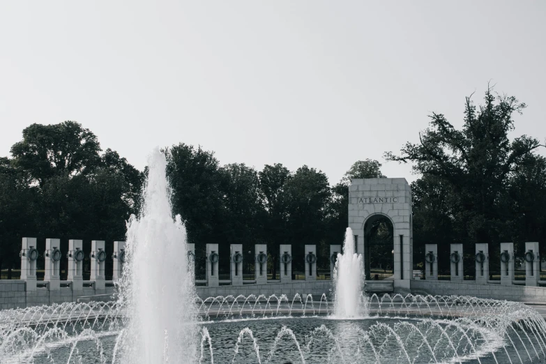 a fountain in front of the world war ii memorial, by Cherryl Fountain, pexels contest winner, hurufiyya, white stone arches, background image, tie-dye, 2 0 2 2 photo