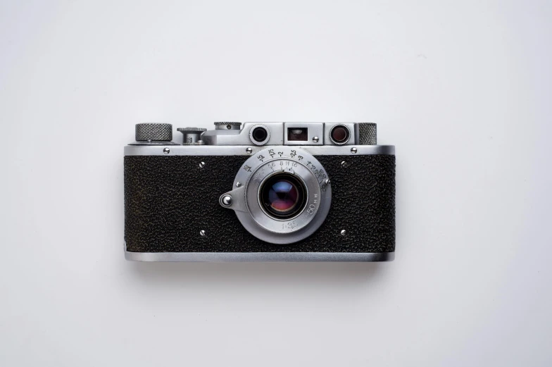 a black and silver camera on a white surface, by Gavin Hamilton, unsplash contest winner, photorealism, vintage - w 1 0 2 4, flat minimalistic, historical photo, leica lens high quality