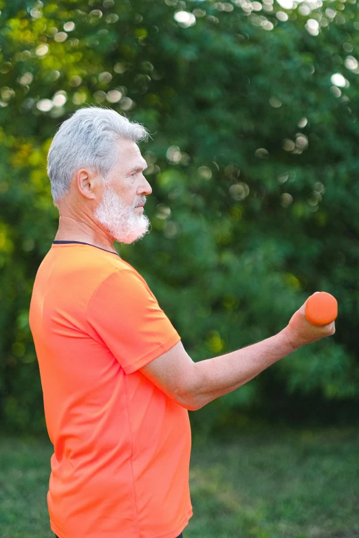 a man in an orange shirt holding two orange balls, inspired by Hans Mertens, happening, gray haired, profile image, square, holding a torch