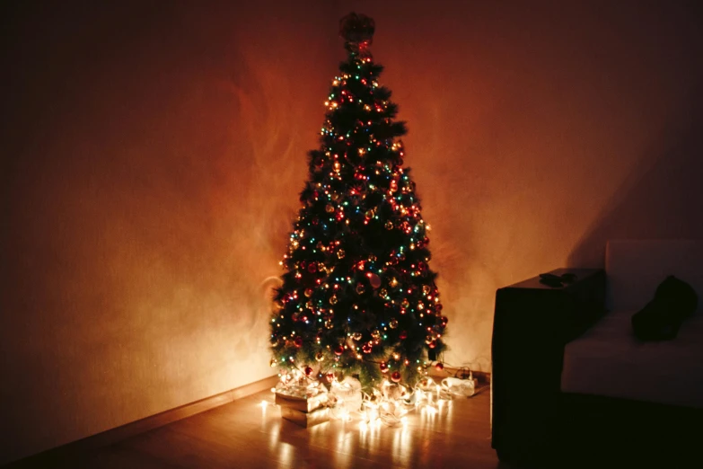 a lit christmas tree in the corner of a room, by Julia Pishtar, pexels, hurufiyya, profile image, bottom angle, multiple stories, 5 feet away