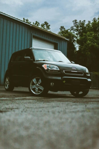 a black suv parked in front of a building, by Chris Rallis, unsplash, renaissance, kia soul, taken in the 2000s, profile picture, slight overcast lighting