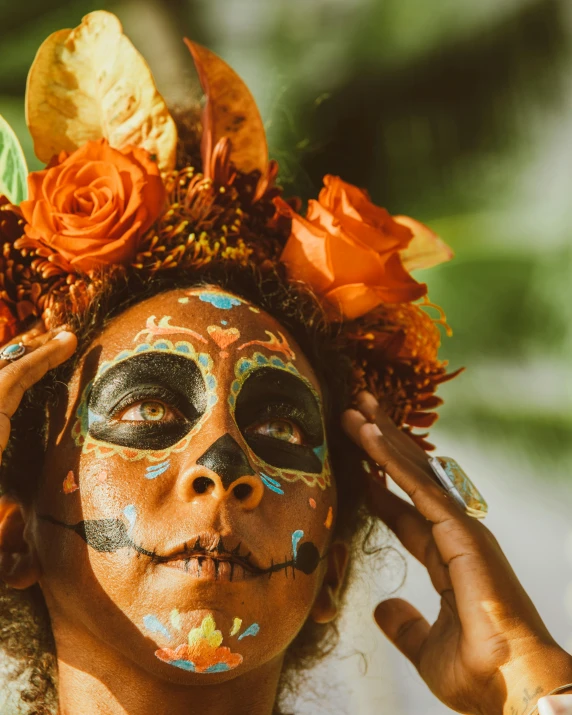 a woman with face paint and flowers on her head, an album cover, pexels contest winner, sumatraism, mexico, lgbtq, trick or treat, indigenous man