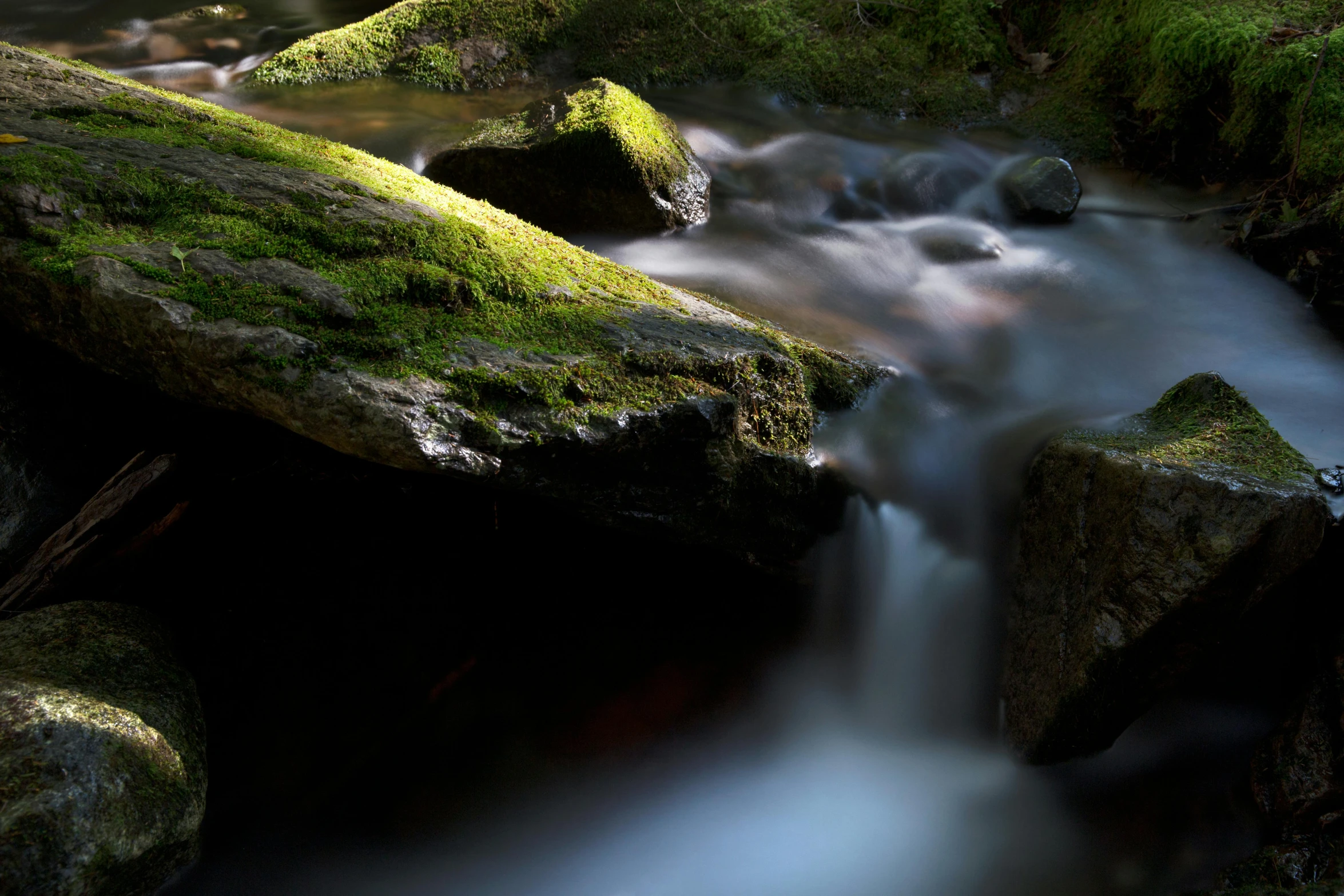 a stream running through a lush green forest, unsplash contest winner, tonalism, floating rocks, medium format. soft light, lpoty, dark rocks