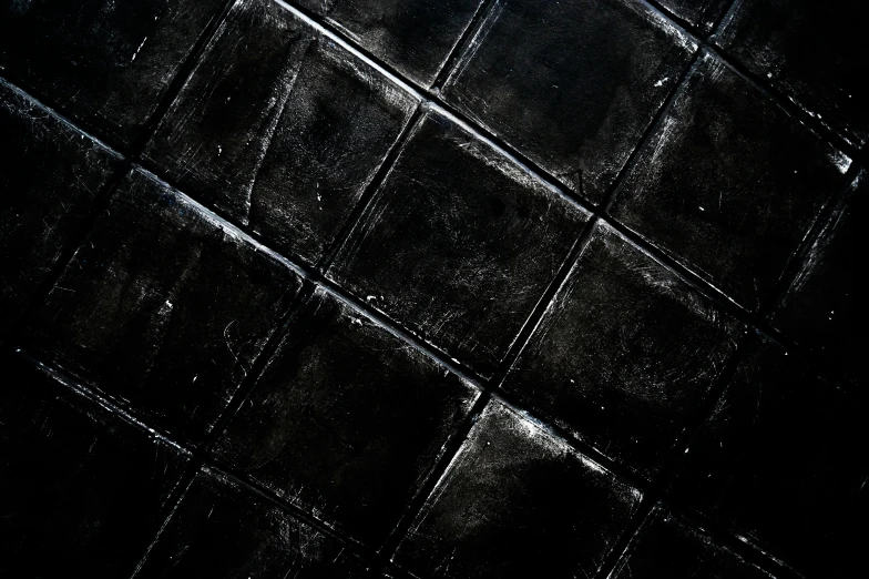 a black tiled floor in a dark room, an album cover, inspired by Pierre Soulages, unsplash, background image, plastic texture, jelly - like texture. photograph, black draconic - leather