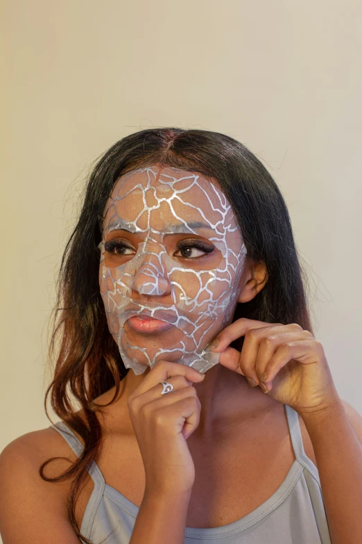 a woman with white paint on her face, crackles, foil effect, ( ( dark skin ) ), dark natural glow