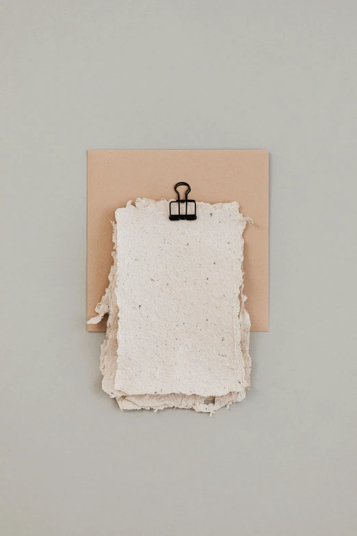 a piece of paper hanging on a wall, by Simon Gaon, card frame, loose papers, sustainable materials, 15081959 21121991 01012000 4k