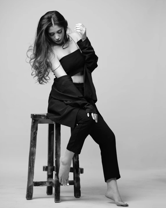 a woman sitting on top of a wooden stool, a black and white photo, unsplash, baroque, :: madison beer, wearing black modern clothes, ariana grande photography, artem chebokha