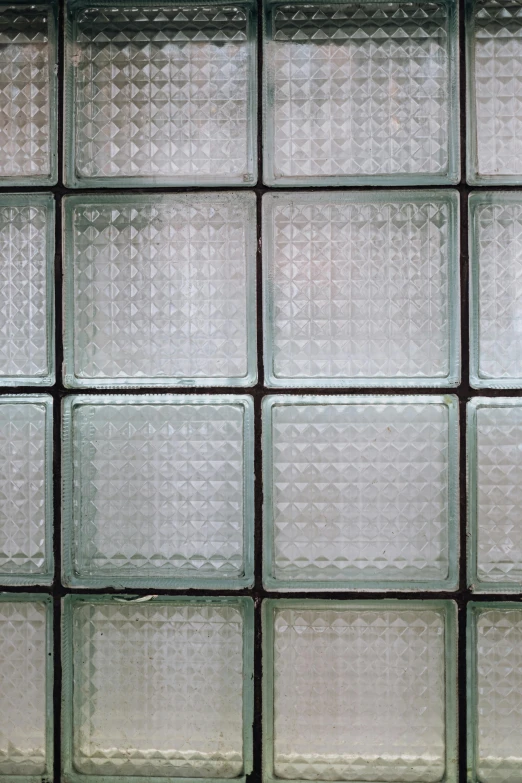 a red fire hydrant sitting in front of a glass block wall, inspired by Agnes Martin, unsplash, repeating pattern, bumps, transparent glasses, square