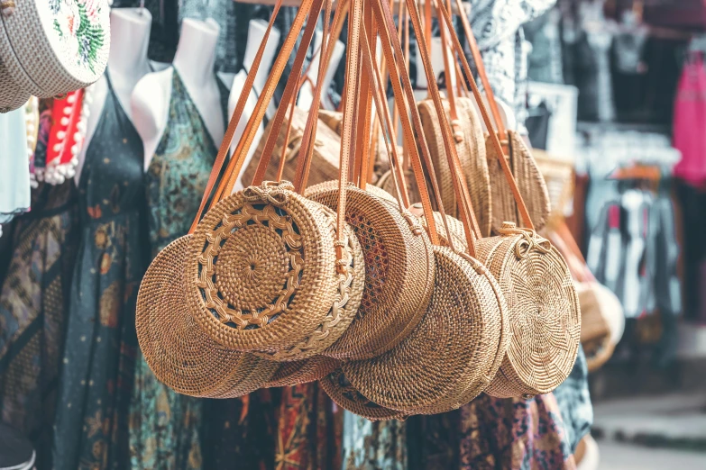 a bunch of wicker bags hanging from a rack, trending on pexels, circle, batik, thumbnail, surrounding the city
