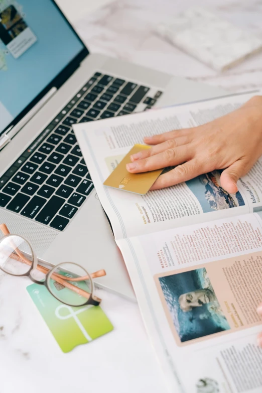 a person sitting in front of a laptop on a bed, private press, biology textbook page, gold encrustations, ecommerce photograph, thumbnail