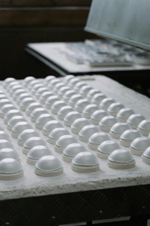 a computer keyboard sitting on top of a table, a marble sculpture, many cryogenic pods, production ready, white cap, domes