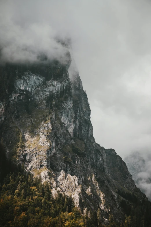 a mountain on a cloudy day with trees in the foreground, pexels contest winner, baroque, steep cliffs, switzerland, 4k footage, multiple stories