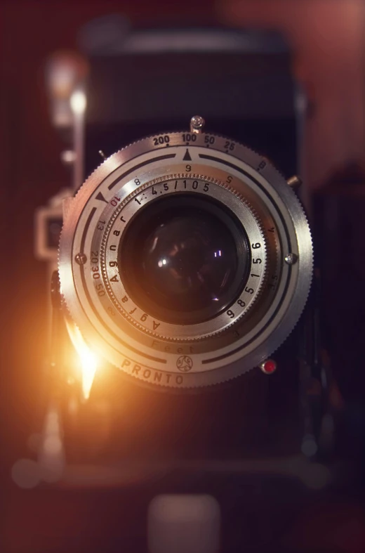 a close up of a camera on a table, by IAN SPRIGGS, unsplash, photorealism, lens flares. cinematic, 8k artistic 1920s photography, cinematic. by leng jun, center frame medium shot