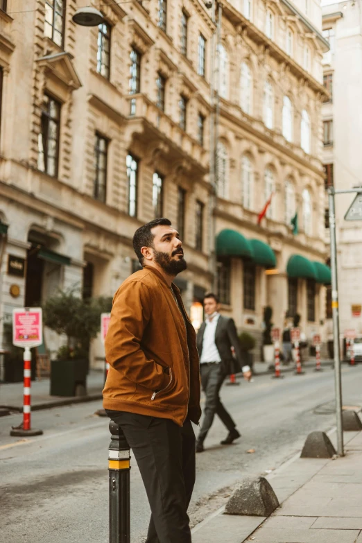 a man standing on the side of a street, inspired by Nadim Karam, pexels contest winner, renaissance, brown jacket, istanbul, profile image, 🚿🗝📝