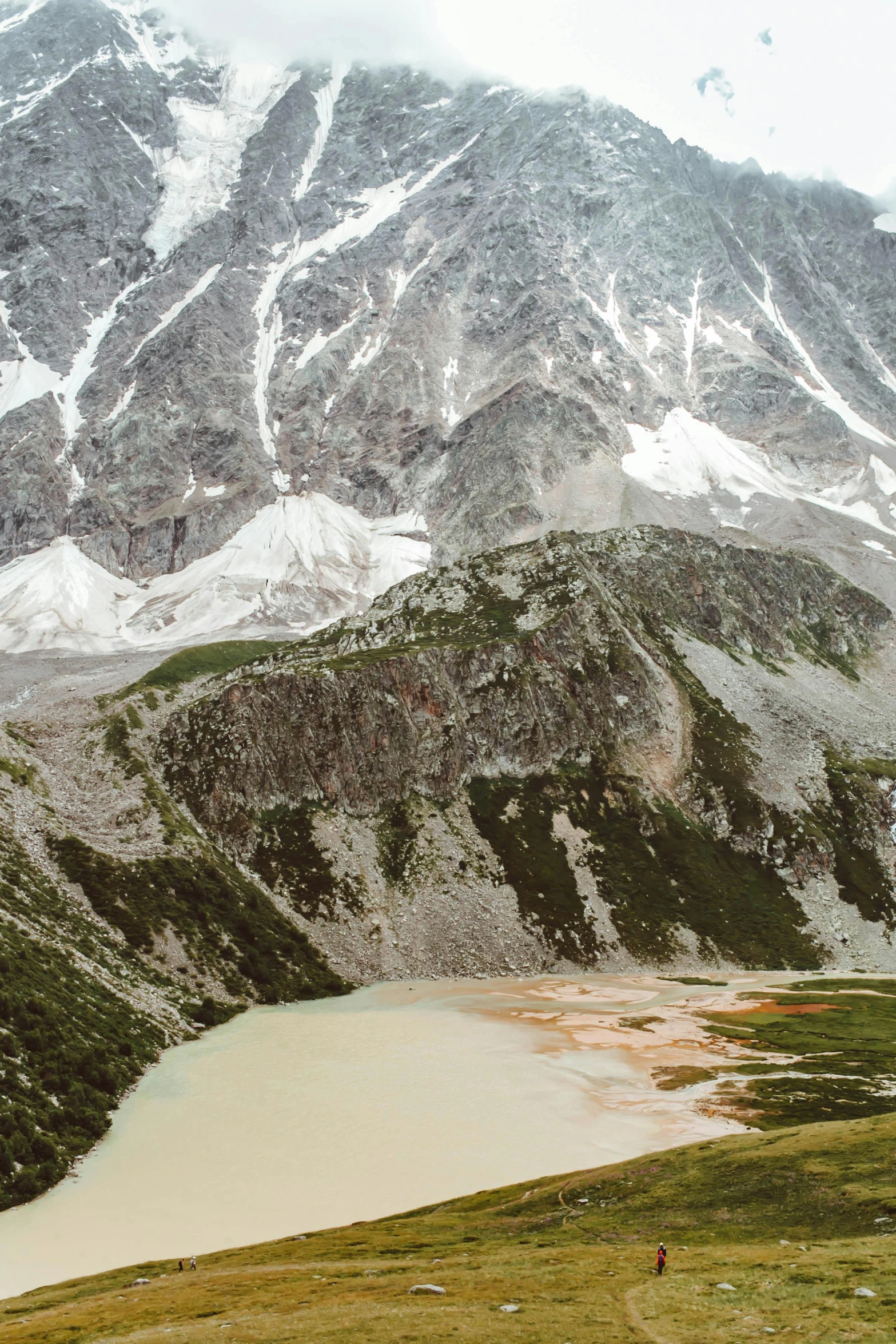 a herd of cattle standing on top of a lush green hillside, inspired by Konstantin Vasilyev, trending on unsplash, land art, frozen lake, view from helicopter, kazakh empress, mountains of ice cream