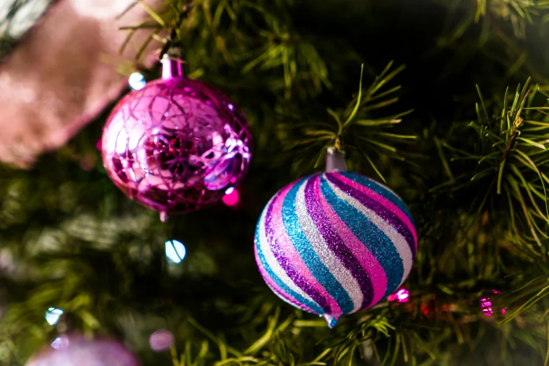 a close up of a christmas tree with ornaments, by Joe Bowler, pexels, fuchsia and blue, male and female, a wide shot, multicoloured