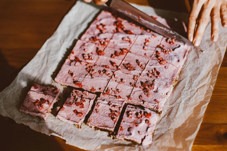 a close up of a person cutting a cake with a knife, by Emma Andijewska, pexels, happening, pink concrete, squares, snacks, thumbnail