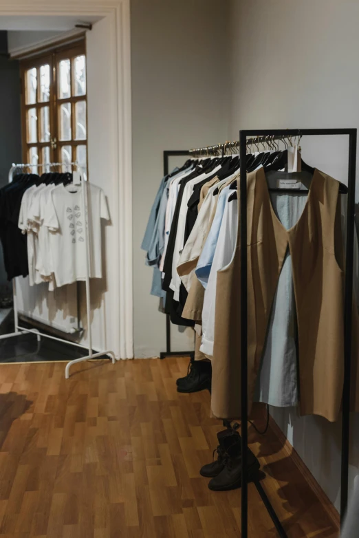 a room that has a bunch of clothes on a rack, by Nina Hamnett, unsplash, renaissance, wear's beige shirt, tech robes, thumbnail, storefront