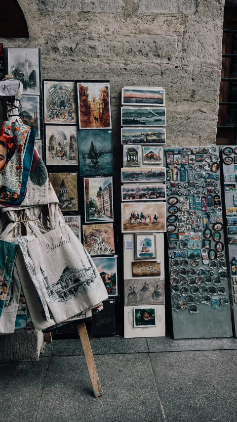 a mannequin in front of a wall with pictures on it, trending on pexels, market stalls, seen from above, intricate painting, papers on table