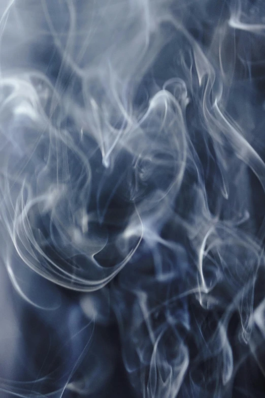 a close up of smoke on a black background, by David Donaldson, pexels, pale blue fog, flowing tendrils, praying with tobacco, photograph taken in 2 0 2 0