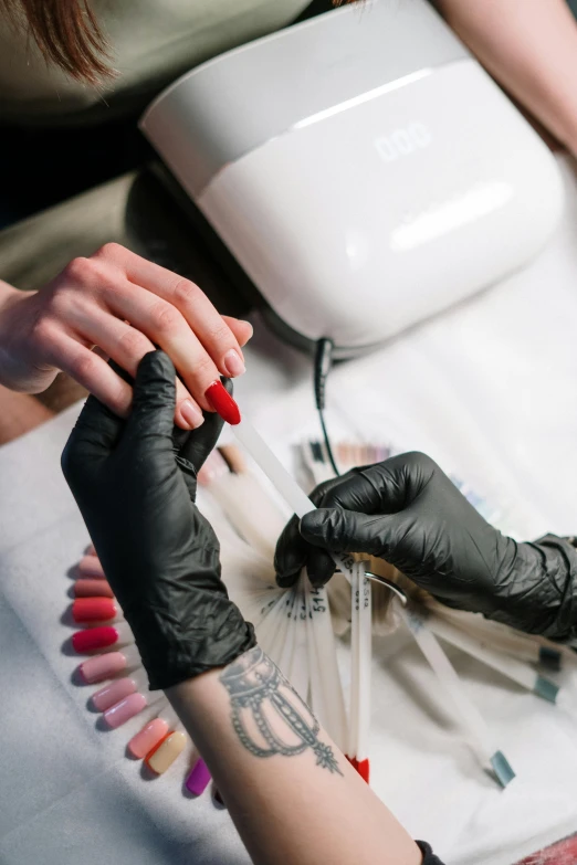 a woman getting her nails done at a salon, a tattoo, by Adam Marczyński, trending on pexels, test tubes, ilustration, high heels and gloves. motion, thumbnail