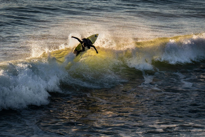 a man riding a wave on top of a surfboard, by Niko Henrichon, unsplash contest winner, evening sunlight, mid air, thumbnail, 8k octan photo