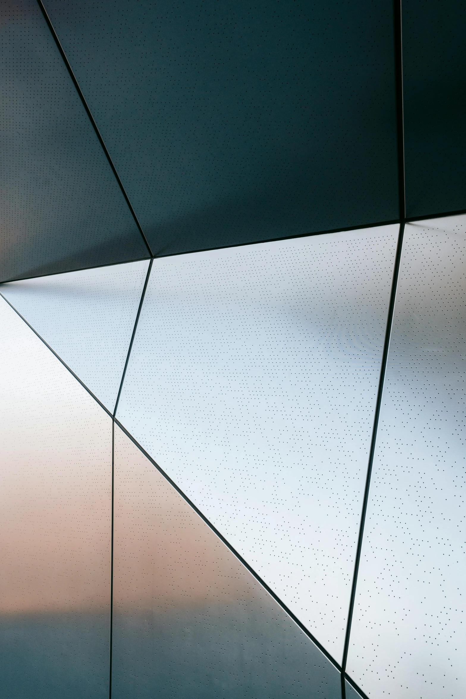 a close up of a building with a sky in the background, by Doug Ohlson, unsplash, geometric abstract art, metal panels, pearlescent hues, triangle, gradient black to silver