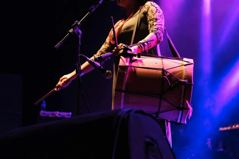 a woman that is standing in front of a microphone, an album cover, flickr, hurufiyya, band playing instruments, panoramic shot, ritu kumar, lachlan bailey