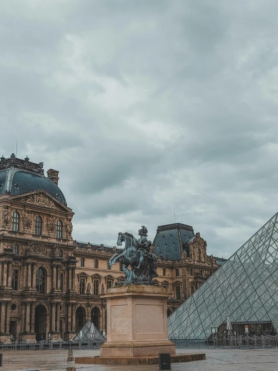 a large building with a glass pyramid in front of it, a photo, by Julia Pishtar, pexels contest winner, bronze statue and silver, features between french, thumbnail, square