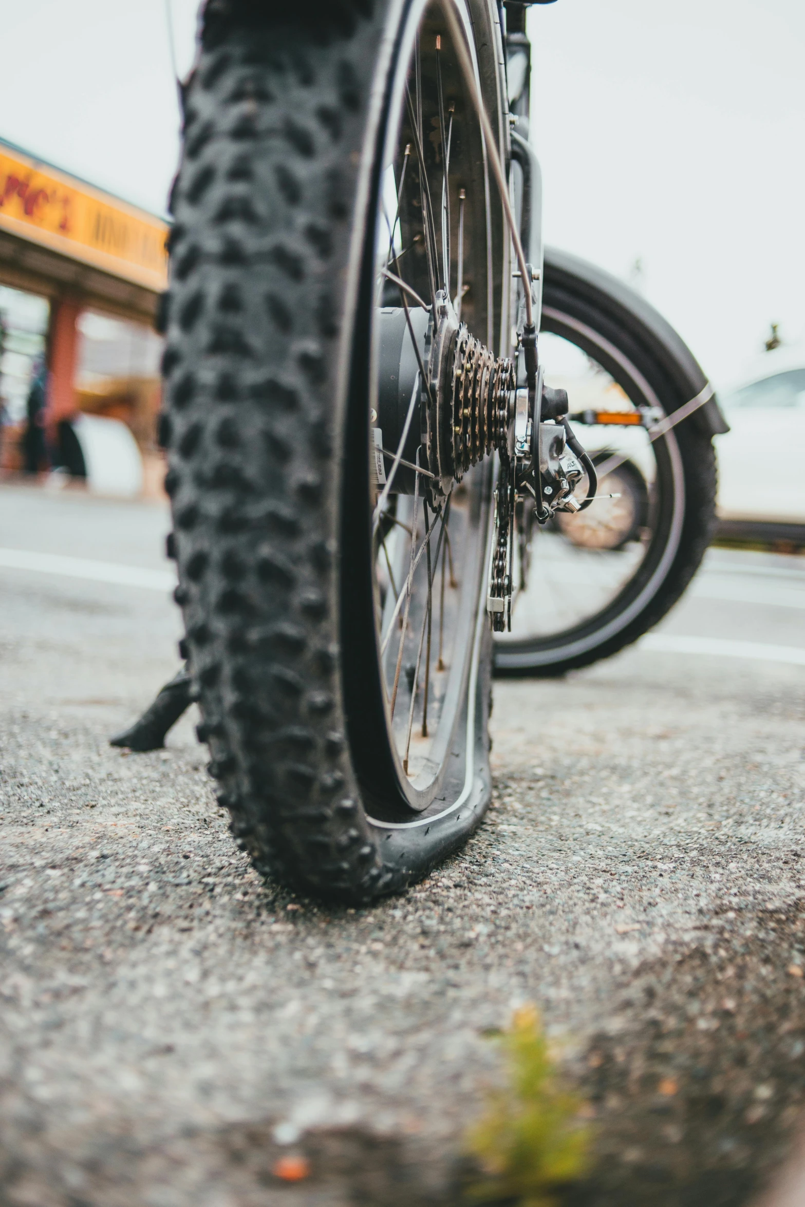 a bicycle parked on the side of the road, slick tires, up close, story, multiple stories