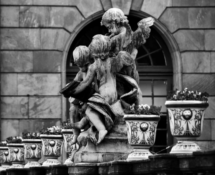 a black and white photo of a statue in front of a building, a statue, by Cherryl Fountain, pexels contest winner, 2 angels, cute photo, hannover, rich composition