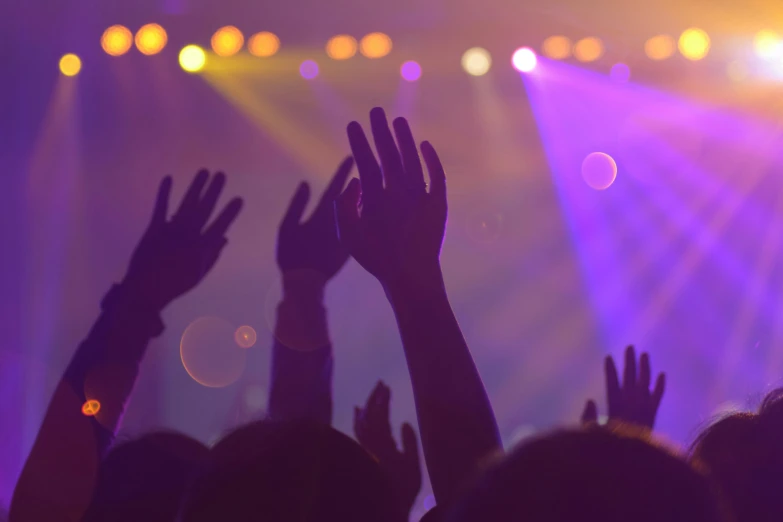 a group of people raising their hands at a concert, an album cover, pexels, purple lights, coloured, getty images, youtube thumbnail