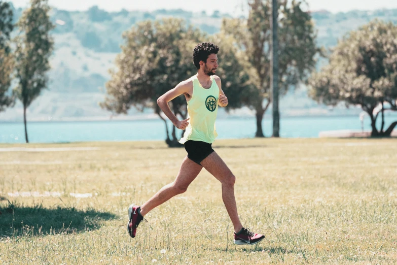 a man running across a grass covered field, 🚿🗝📝, in a race competition, eytan zana, avatar image