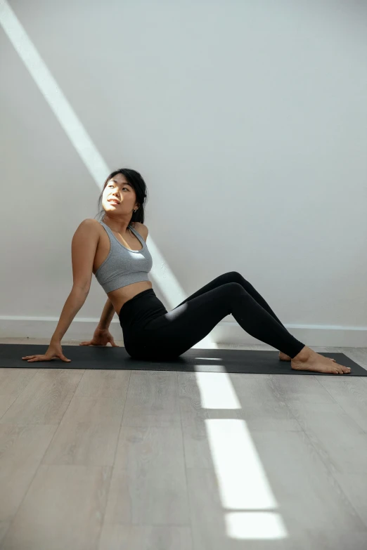 a woman sitting on a yoga mat in a room, by Natasha Tan, arabesque, arms to side, profile image, sun yunjoo, looking partly to the left
