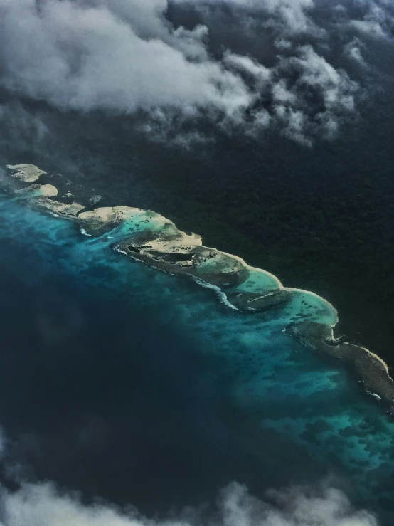 an aerial view of an island in the middle of the ocean, by Daren Bader, pexels contest winner, sumatraism, on a dark background, eagle coral, puddles of turquoise water, thumbnail