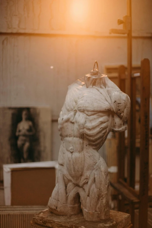 a sculpture of a bear sitting on top of a table, a marble sculpture, trending on pexels, academic art, portrait of muscular, in a workshop, in the evening, standing