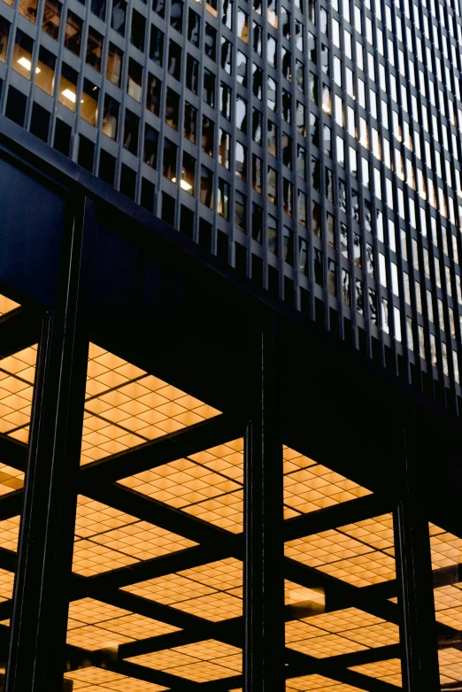 a clock mounted to the side of a tall building, inspired by Donald Judd, modernism, sunset lighting ominous shadows, overhead canopy, buildings covered in black tar, color ektachrome photograph