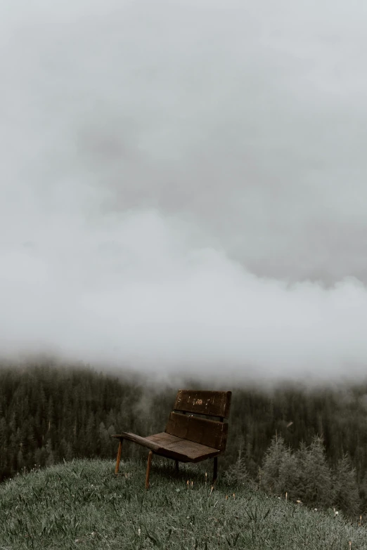 a wooden bench sitting on top of a lush green hillside, a picture, pexels contest winner, romanticism, melting volumetric smoke and fog, on an icy throne, sittin