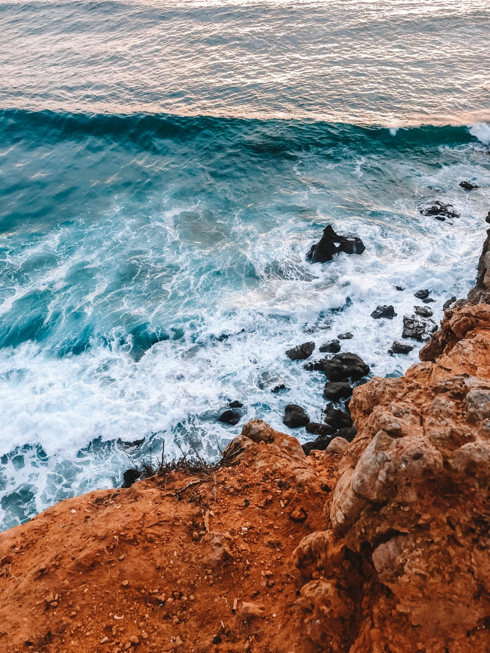 a view of the ocean from a cliff, by Niko Henrichon, pexels contest winner, waves crashing, red sea, middle close up shot, high quality product image”