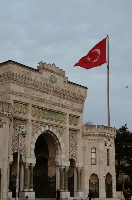 a large building with a flag flying in front of it, inspired by Osman Hamdi Bey, torri gate, university, military buildings, square