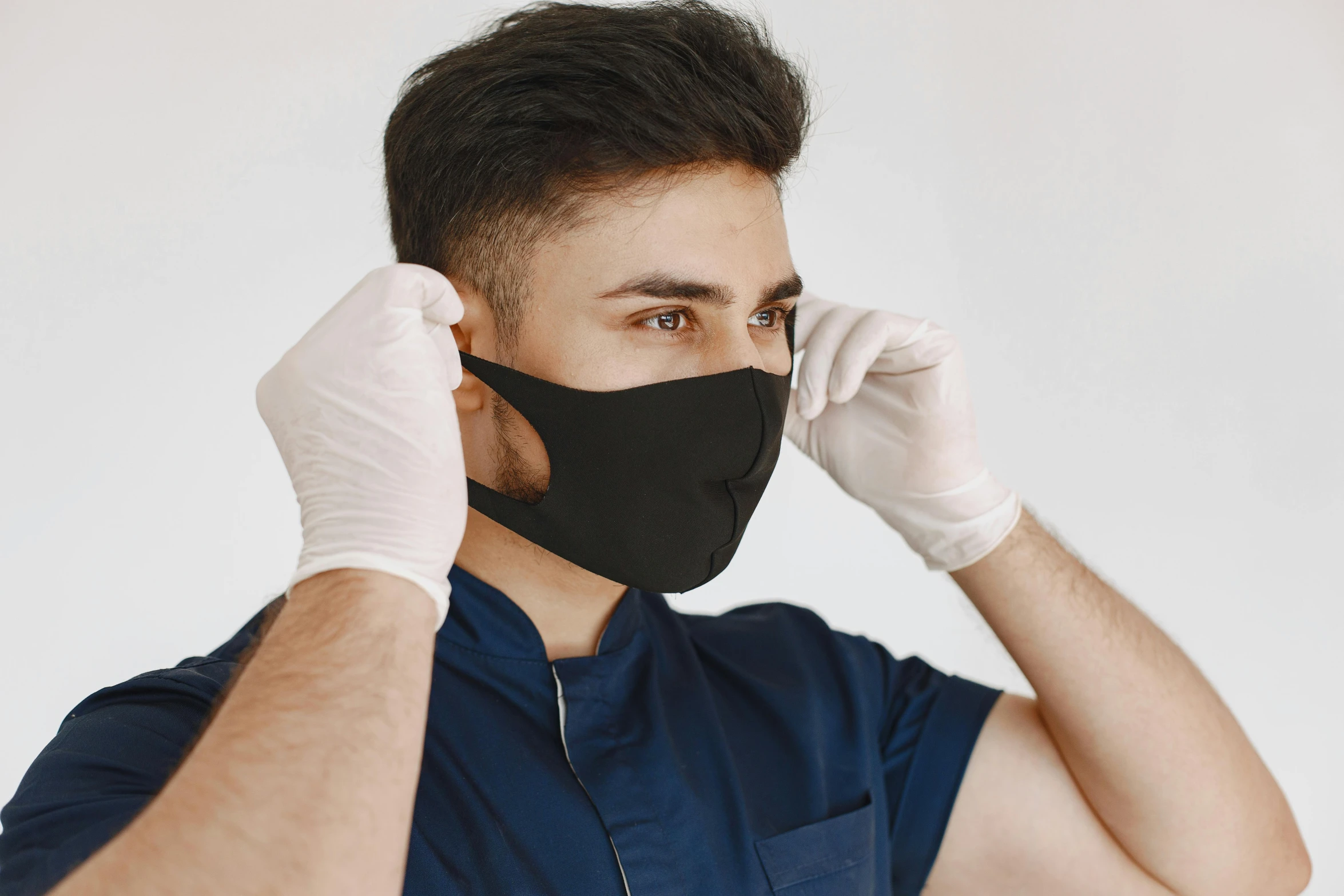 a man wearing white gloves and a black mask, by Adam Marczyński, shutterstock, square masculine jaw, surgical gown and scrubs on, cutest, youtube thumbnail