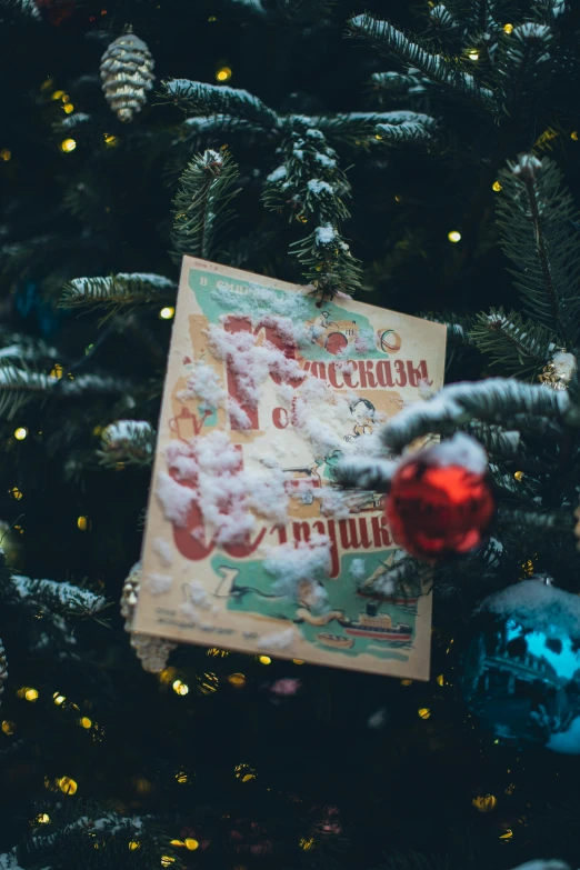 a book sitting on top of a christmas tree, an album cover, by Maksimilijan Vanka, pexels contest winner, russian, ticket, soft, thumbnail