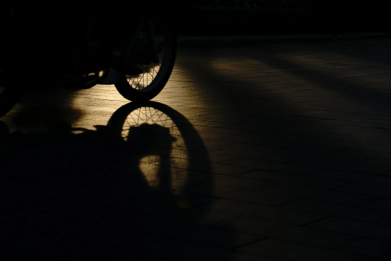 a shadow of a person riding a bike, by Gusztáv Kelety, pexels contest winner, photorealism, symmetrical rim light, (night), metalic reflection, morning detail