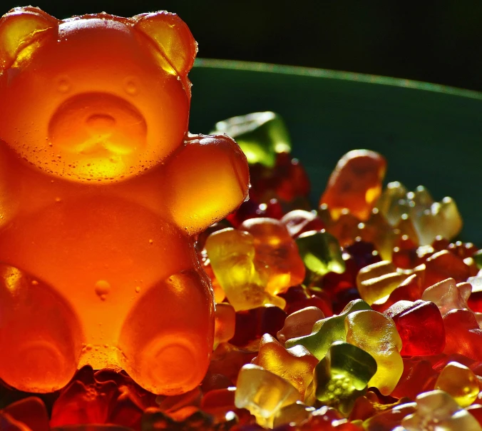 a close up of a bowl of gummy bears, an album cover, by Julia Pishtar, pexels, backlit glow, carved soap, marmalade, beads