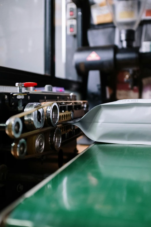 a metal pan sitting on top of a green counter, a silk screen, unsplash, private press, industrial robots, small spacecraft in background, high quality photo, inspect in inventory image