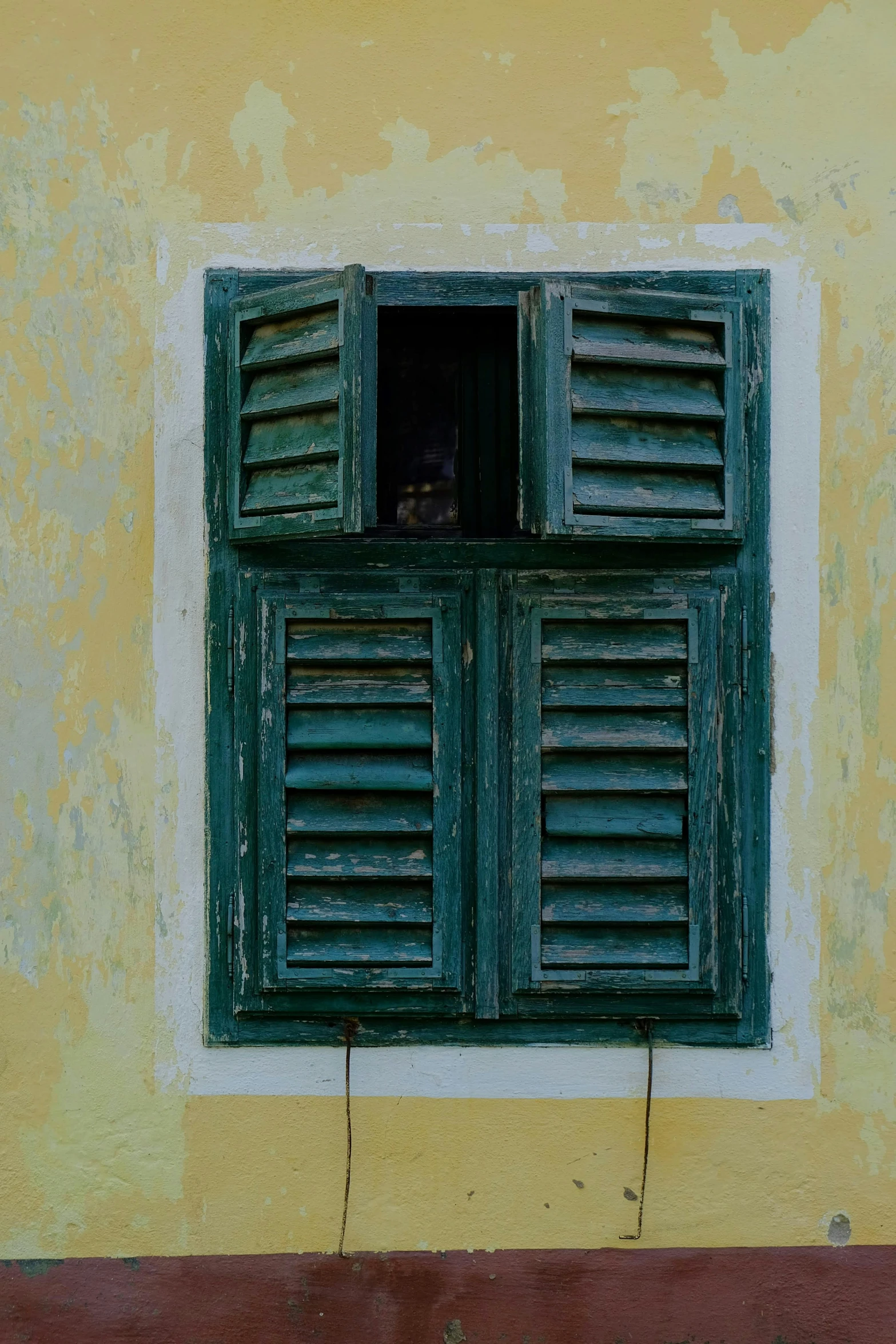 a red fire hydrant sitting in front of a yellow building, an album cover, by Sven Erixson, pexels contest winner, renaissance, cyan shutters on windows, laos, muted green, photo of a beautiful window