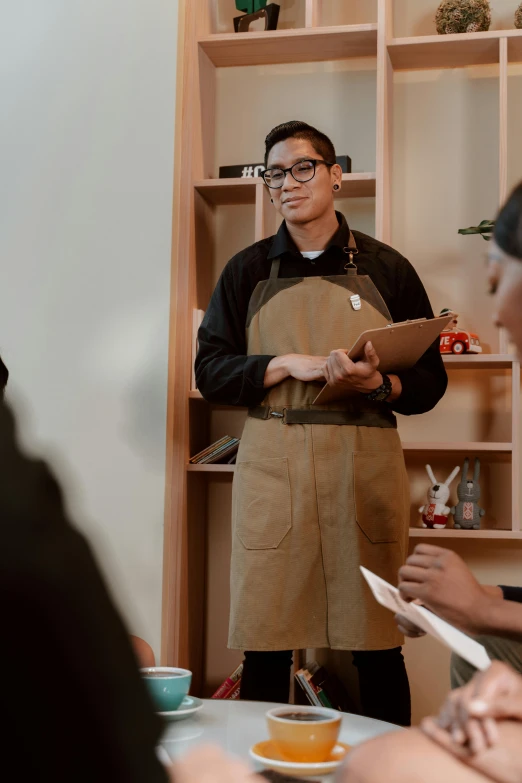 a group of people sitting around a table, white apron, darren quach, holding a clipboard, in detail