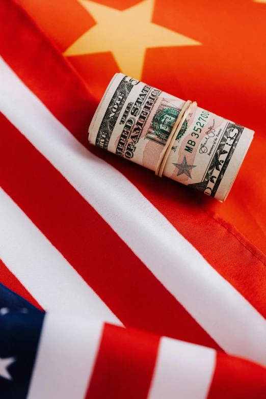 a roll of money sitting on top of an american flag, thumbnail, lgbtq, usa, georgeus