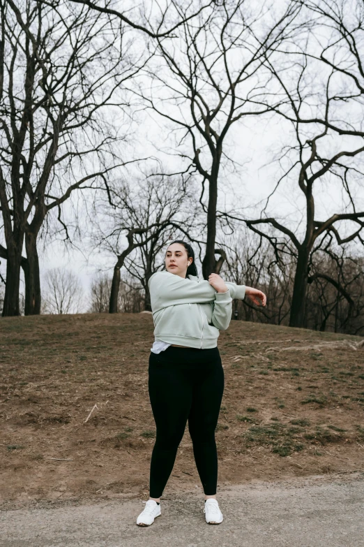 a woman throwing a frisbee in a park, an album cover, by Grace Polit, unsplash, depressed dramatic bicep pose, central park, thicc, cold as ice! 🧊